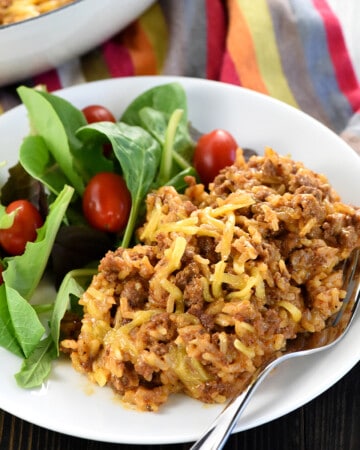 Homemade Taco Hamburger Helper on plate with salad.
