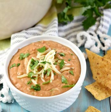 Ultimate Bean Dip ~ requiring a handful of simple ingredients -- refried beans, cream cheese, salsa, pepper jack, and cilantro -- and taking just 10 minutes to make, this stove-top appetizer recipe is creamy and cheesy...the perfect snack for parties or for watching the big game! | FiveHeartHome.com