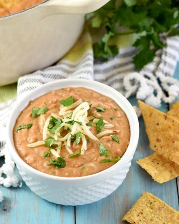 Ultimate Bean Dip ~ requiring a handful of simple ingredients -- refried beans, cream cheese, salsa, pepper jack, and cilantro -- and taking just 10 minutes to make, this stove-top appetizer recipe is creamy and cheesy...the perfect snack for parties or for watching the big game! | FiveHeartHome.com