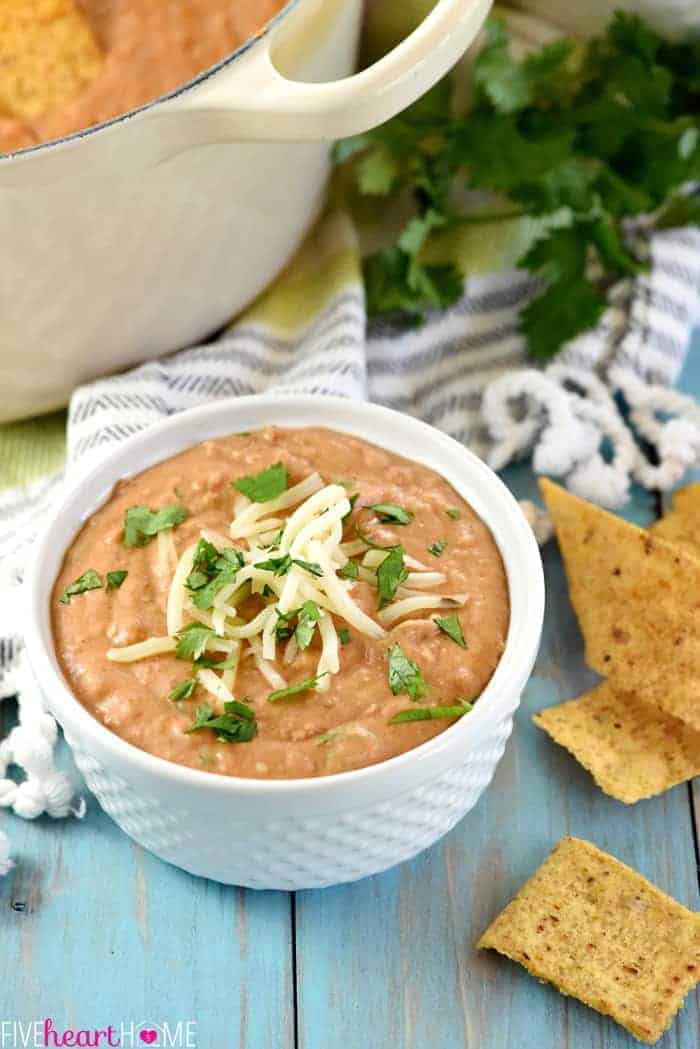 Bean Dip in a white serving bowl with garnish 