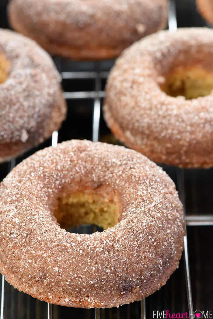 Baked Apple Cider Donuts ~ these delicately spiced, 100% whole wheat donuts are tender on the inside and coated in crunchy cinnamon sugar on the outside for a tasty fall breakfast treat! | FiveHeartHome.com Baked Apple Cider Donuts cooling on a rack.