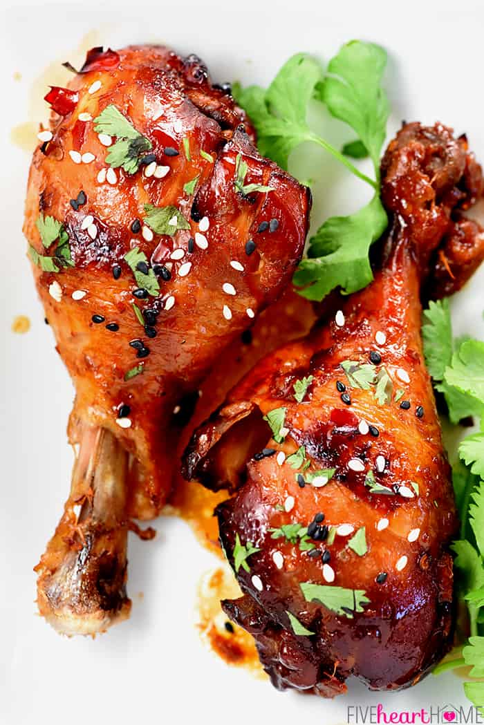 Aerial shot of two Crockpot Chicken Drumsticks sprinkled with sesame seeds and cilantro