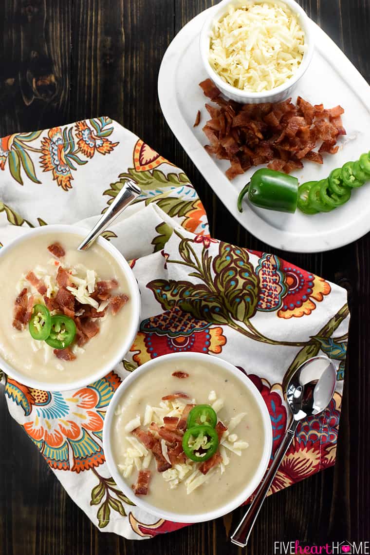 Aerial view of two bowls with platter of garnishes.