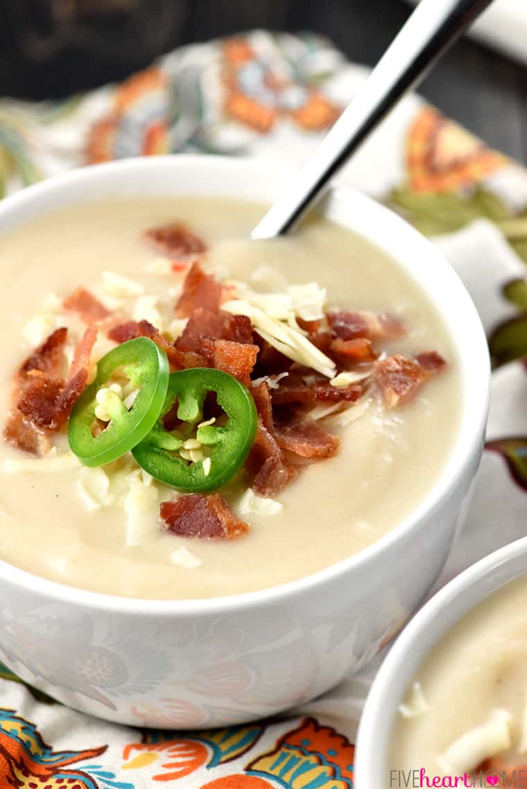 Bowl of Cauliflower Soup garnished with cheese, bacon, and jalapeños..