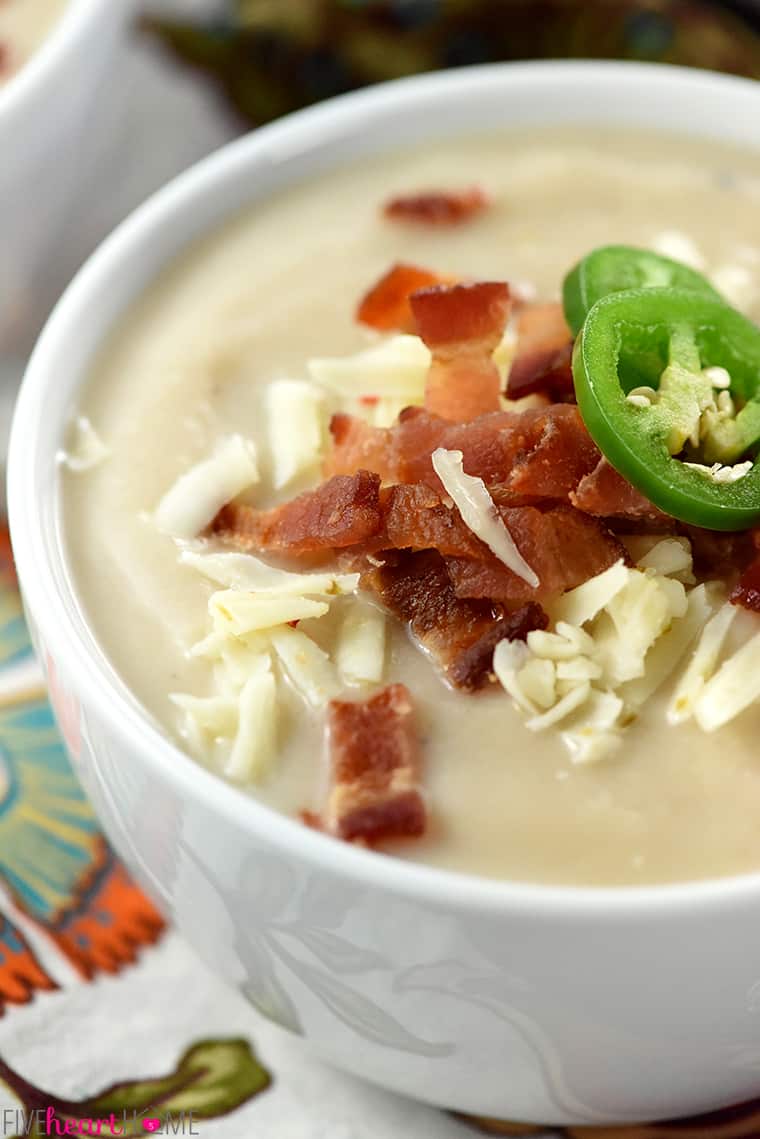 Close-up of bowl of Cauliflower Soup with garnishes.