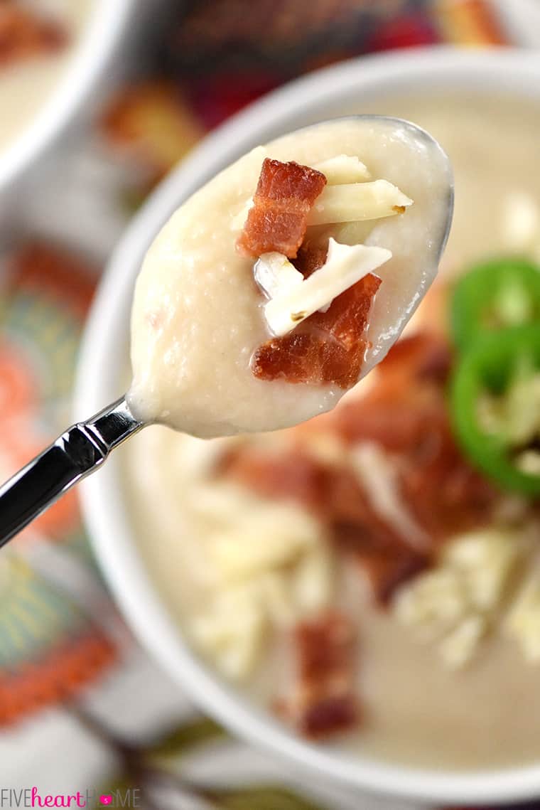 Spoonful suspended over bowl.