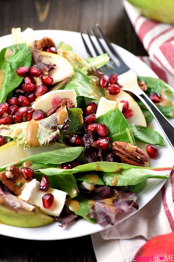 Thanksgiving Salad ~ this gorgeous Pomegranate, Pear, Pecan, & Brie Salad with Homemade Balsamic Vinaigrette Served in a White Bowl 