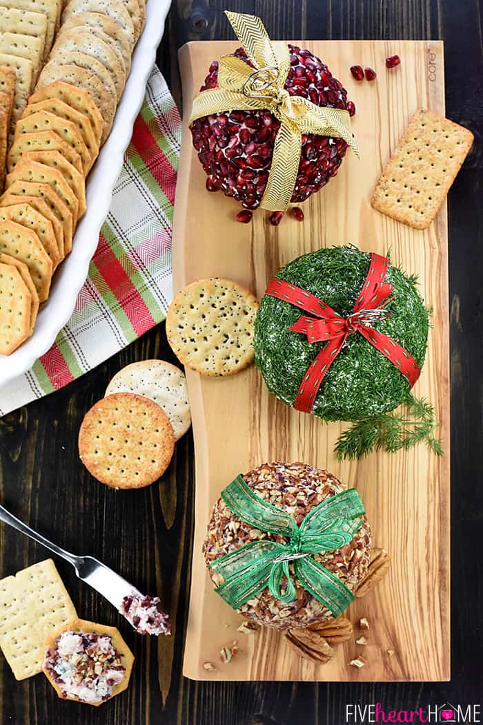 Aerial View of Three Christmas Ornament Cheese Balls with a Platter of Crackers 