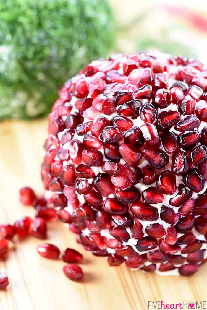 Pomegranates Cover Cheese Ball on Wooden Serving Platter 