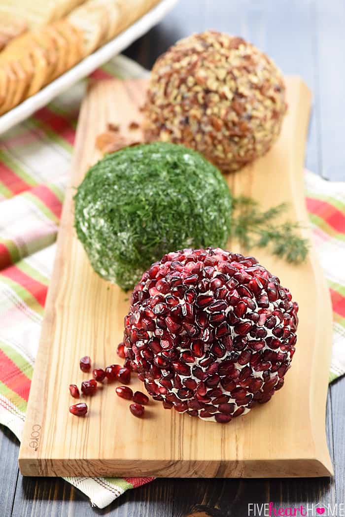 Cranberry, Blue Cheese, & Pecan; Garlic, Feta, & Dill; and White Cheddar, Rosemary, & Pomegranate on a Wooden Serving Bowl 