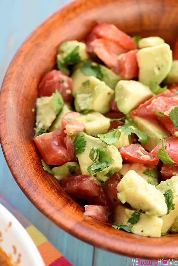 Avocado Tomato Salad in a wooden bowl.