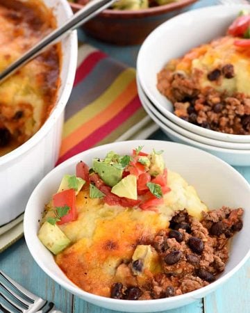 Taco Shepherd's Pie ~ a comfort food classic gets a Tex-Mex twist with taco-seasoned, salsa-spiced ground beef, studded with black beans and topped with cheesy green chile mashed potatoes! | FiveHeartHome.com