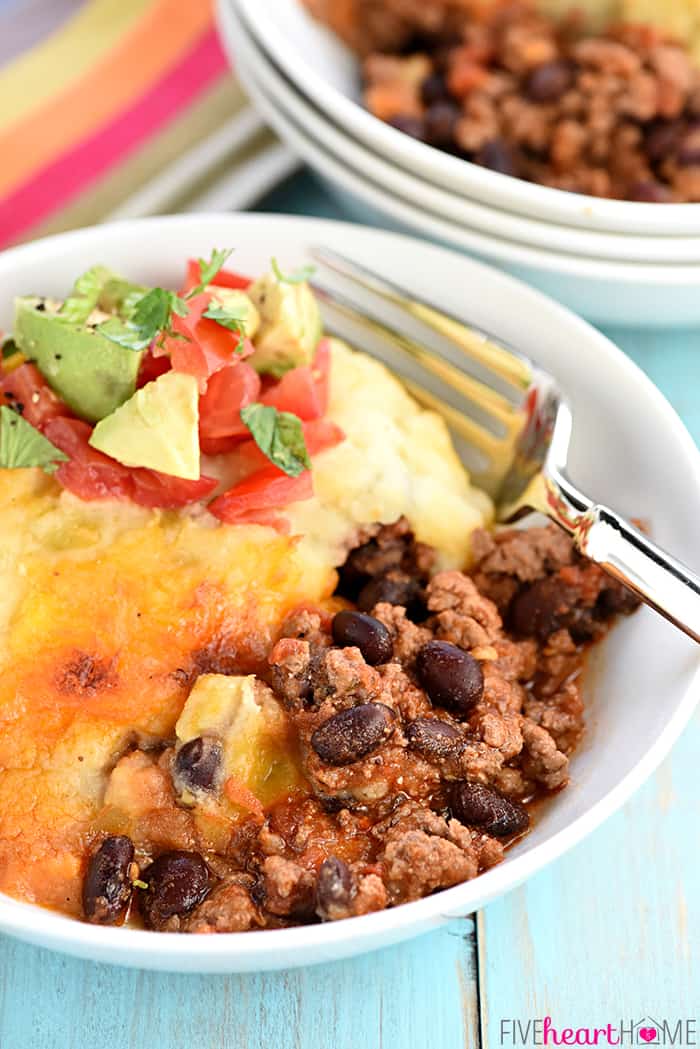 Taco Shepherd's Pie served in a white bowl with a fork.