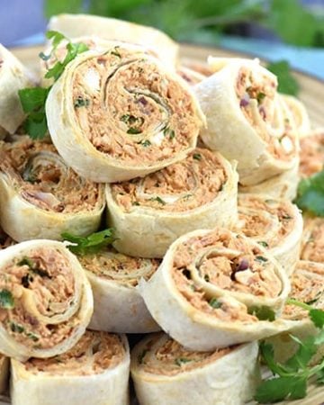 BBQ Chicken Tortilla Pinwheels ~ soft flour tortillas are slathered with a mixture of cream cheese, mozzarella, chicken, bacon, barbecue sauce, red onion, and cilantro, then rolled up tight and sliced in this flavorful, addictive appetizer recipe that's perfect for parties, potlucks, picnics, or game day! | FiveHeartHome.com