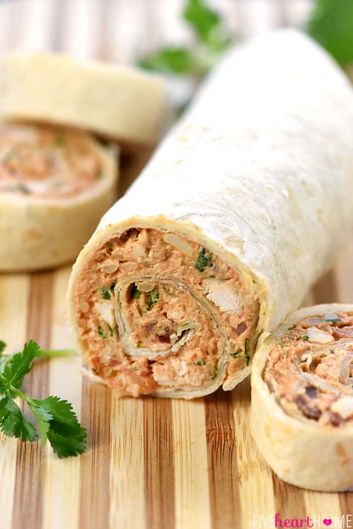 BBQ Chicken Tortilla Pinwheels ~ soft flour tortillas are slathered with a mixture of cream cheese, mozzarella, chicken, bacon, barbecue sauce, red onion, and cilantro, then rolled up tight and sliced in this flavorful, addictive appetizer recipe that's perfect for parties, potlucks, picnics, or game day! | FiveHeartHome.com Roll ready to slice.