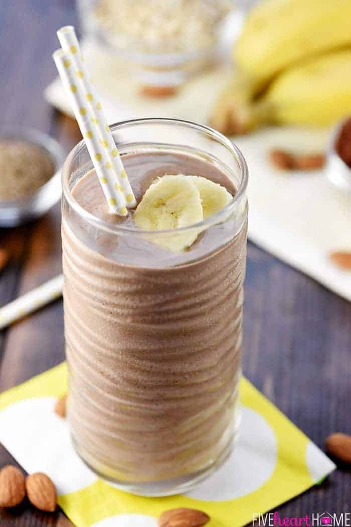 Chocolate Banana Smoothie in a glass with two straws.