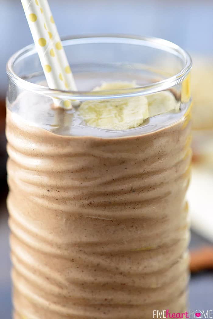 Side view of Chocolate Banana Smoothie in glass with straws.
