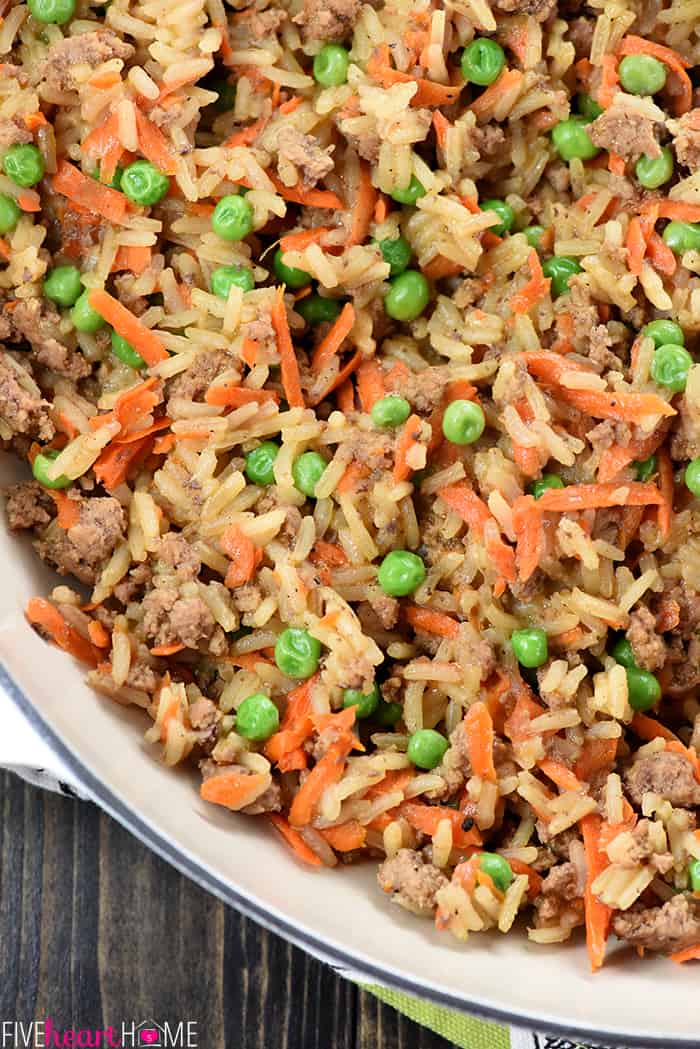 Aerial close-up of recipe made with ground beef, rice, carrots, and peas.