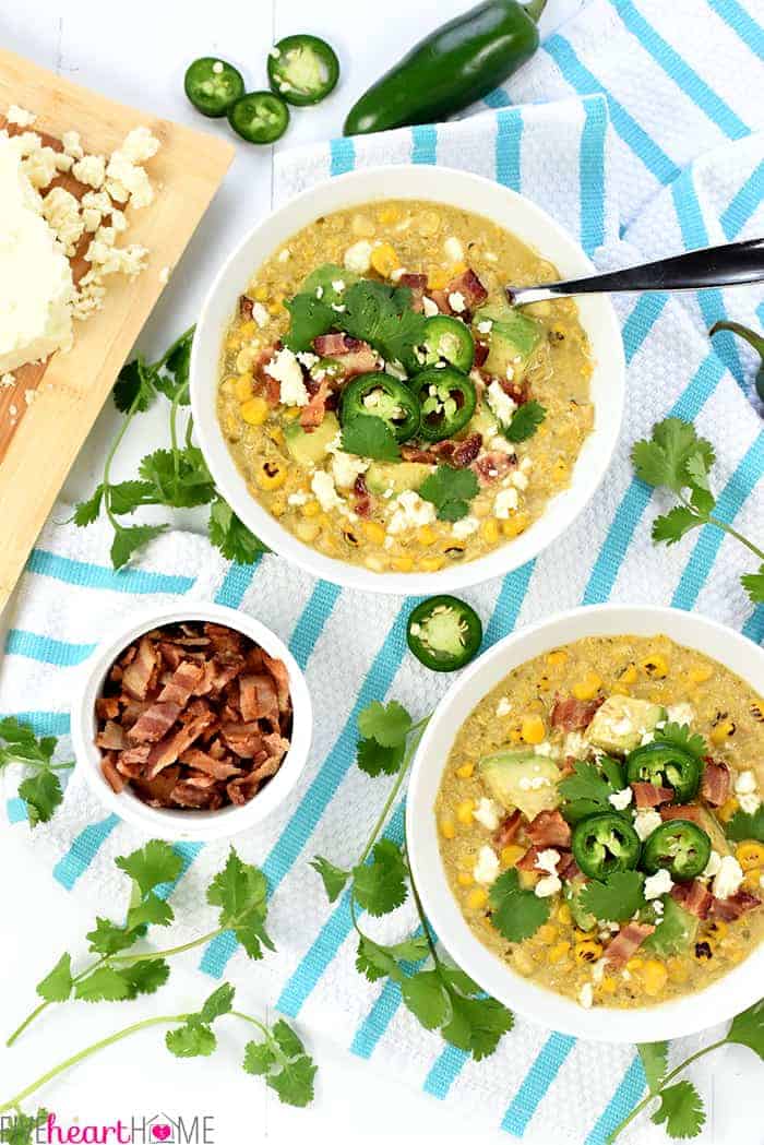 Slow Cooker Mexican Street Corn Chowder ~ the savory flavors of Mexican street corn come together in an easy crock pot soup that's slightly spicy, slightly smoky, and topped with avocado, bacon, cilantro, and cotija cheese! | FiveHeartHome.com Aerial view of bowls of Crockpot Corn Chowder.