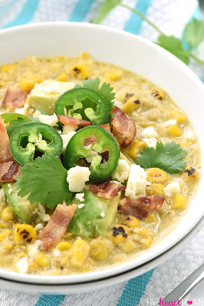 Slow Cooker Mexican Street Corn Chowder ~ the savory flavors of Mexican street corn come together in an easy crock pot soup that's slightly spicy, slightly smoky, and topped with avocado, bacon, cilantro, and cotija cheese! | FiveHeartHome.com Slow Cooker Mexican Street Corn Chowder in a bowl with toppings.