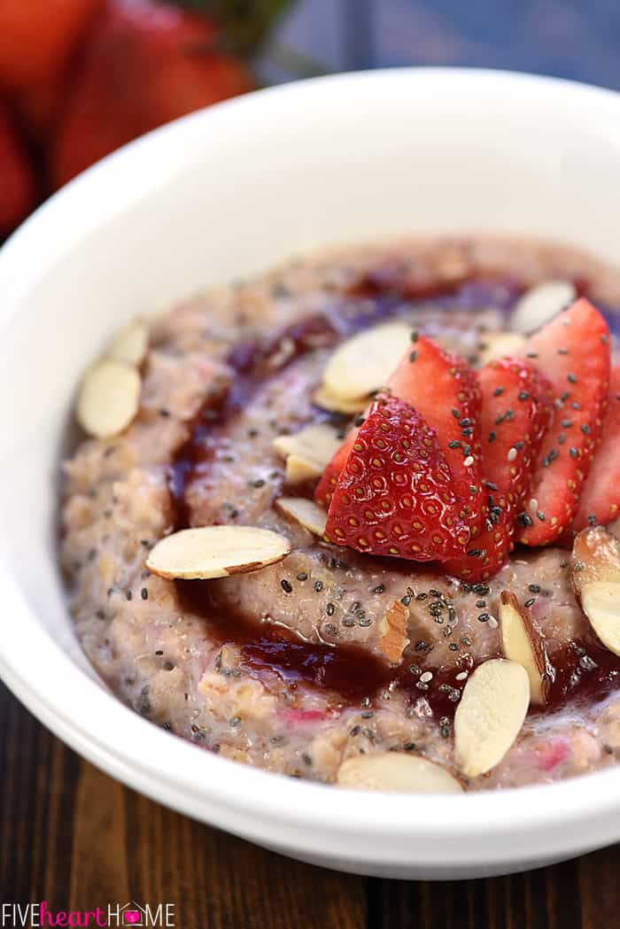 Strawberries & Cream Oatmeal close-up in white bowl, garnished with sliced strawberries and almonds