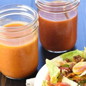 Jars of French Dressing and Catalina Dressing next to salad.