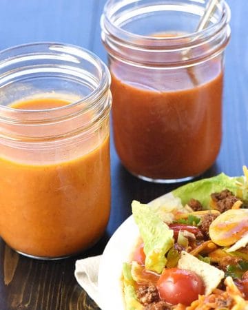 Jars of French Dressing and Catalina Dressing next to salad.