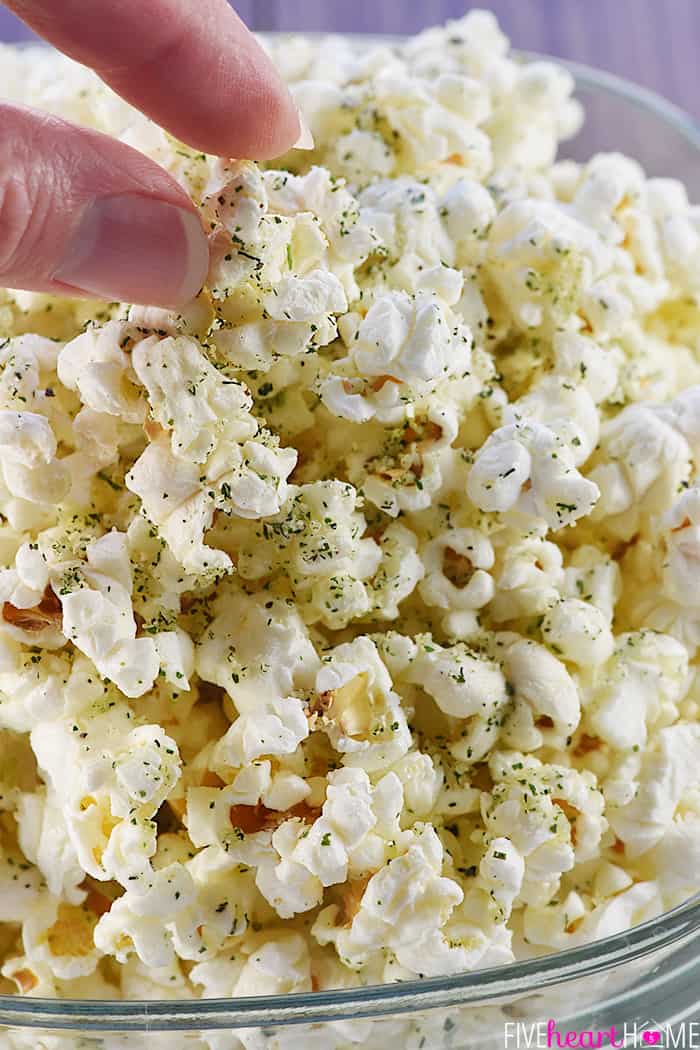 Fingers grabbing some Parmesan Ranch Popcorn.