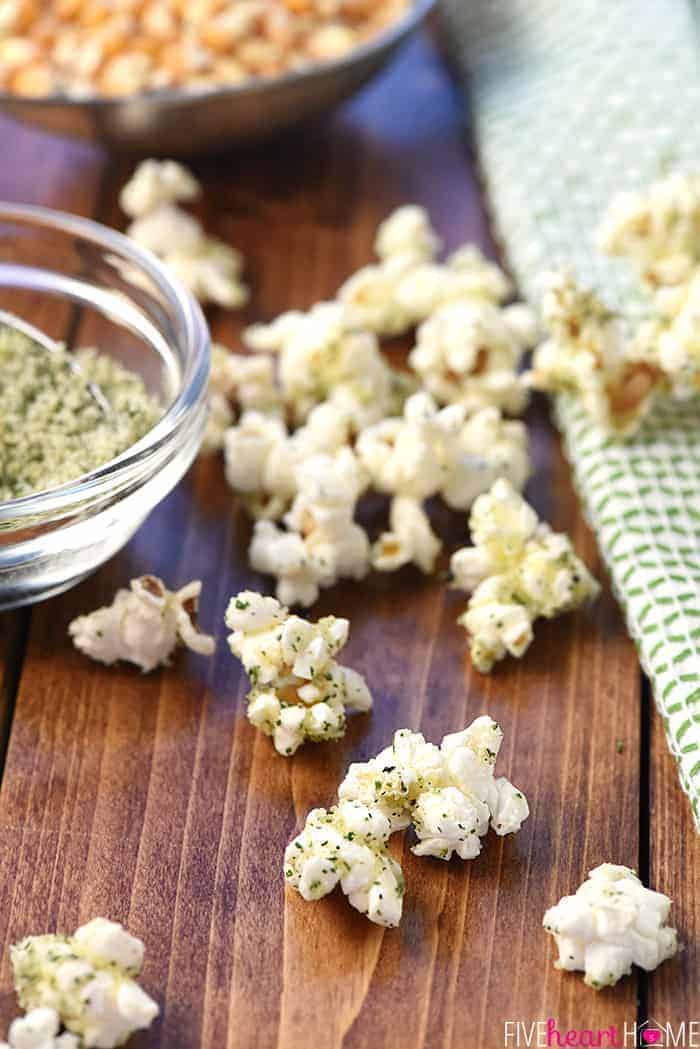 Ranch seasoned popcorn scattered on table.
