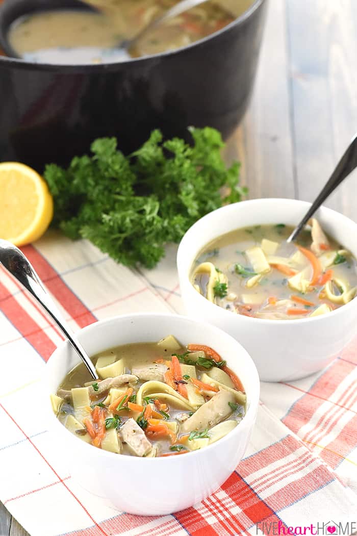 Quick & Easy Homemade Chicken Noodle Soup ~ a delicious, nourishing, cold-buster recipe for getting well soon! | FiveHeartHome.com Two bowls with pot in the background.