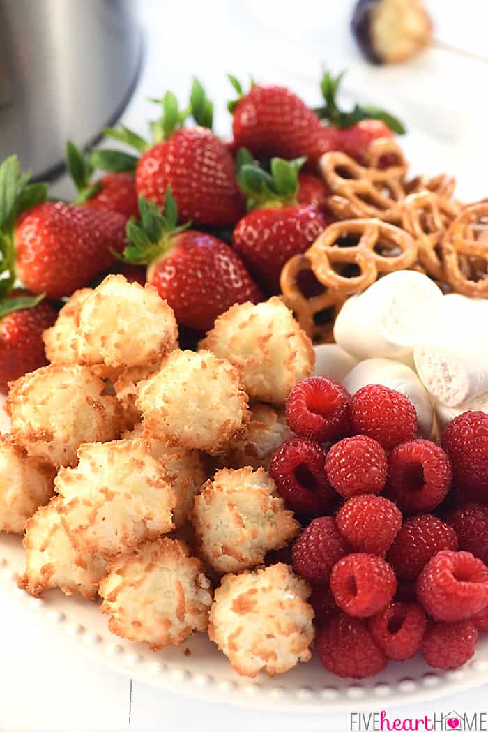 Slow Cooker Chocolate Peanut Butter Fondue ~ a decadent, glossy, chocolate dessert recipe kissed with peanut butter, the perfect crock pot dip for your favorite fruit and confections on Valentine's Day or any day! | FiveHeartHome.com Platter of fruit, cookies, pretzels, and marshmallows for dipping.