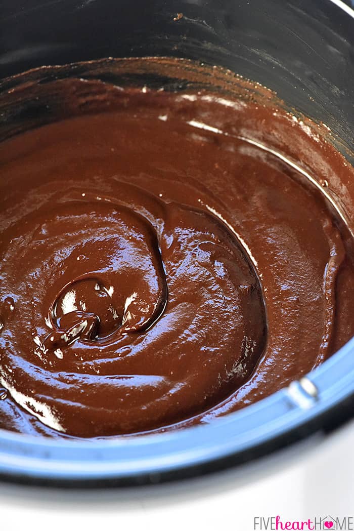 Slow Cooker Chocolate Peanut Butter Fondue ~ a decadent, glossy, chocolate dessert recipe kissed with peanut butter, the perfect crock pot dip for your favorite fruit and confections on Valentine's Day or any day! | FiveHeartHome.com Close-up of Chocolate Peanut Butter Fondue in slow cooker.