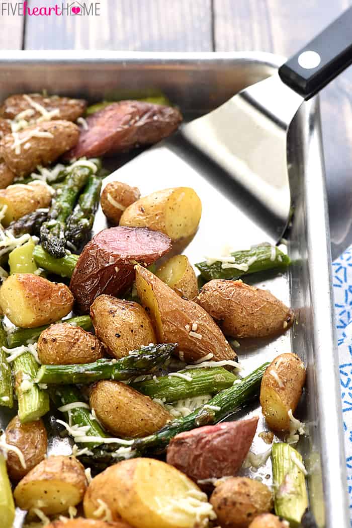 Spatula scooping veggies from baking pan.