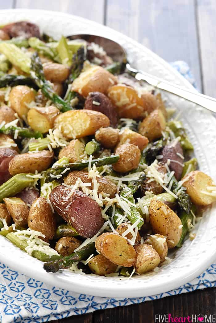 Roasted Potatoes and Asparagus with cheese on a serving platter.