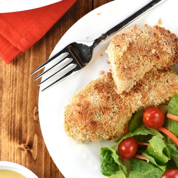 Crunchy Baked Chicken Tenders on plate with salad.