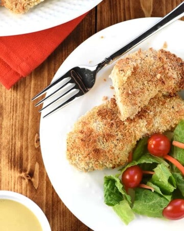 Crunchy Baked Chicken Tenders on plate with salad.