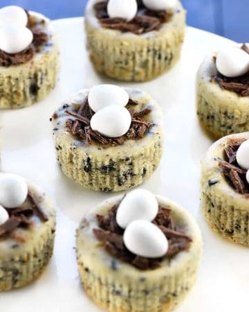 Bird's Nest Mini Oreo Cheesecakes | Easter Dessert Recipe ~ simple cheesecake filling is studded with Oreos, baked in muffin pans, and topped with chocolate shavings and candy eggs for a fun, easy treat that's perfect for spring! | FiveHeartHome.com