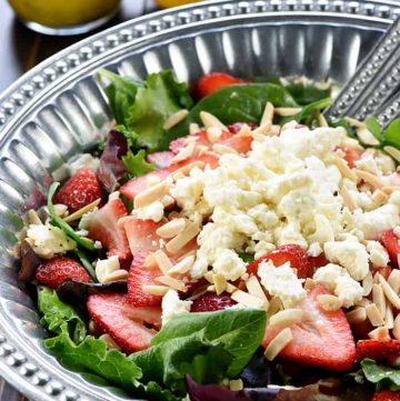 Easter Salad ~ this gorgeous Strawberry Goat Cheese Spring Greens Salad with Toasted Almonds & Lemon Honey Vinaigrette is loaded with vibrant colors and flavors and contrasting textures. It would be the perfect addition to your Easter holiday table, or it would make any dinner special! | FiveHeartHome.com