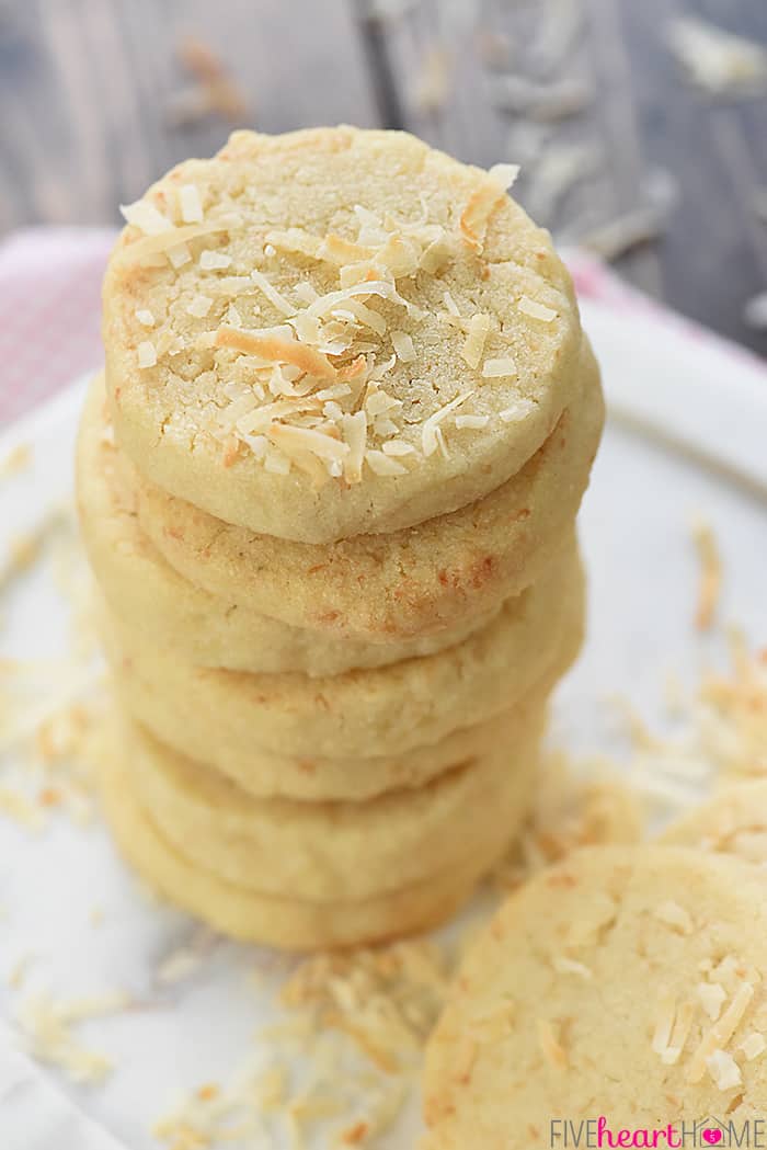 Easy Coconut Shortbread Cookies ~ tender, buttery shortbread is loaded with toasted coconut in this delicious, addictive, easy-to-make recipe! | FiveHeartHome.com Stacked Tall on Plate