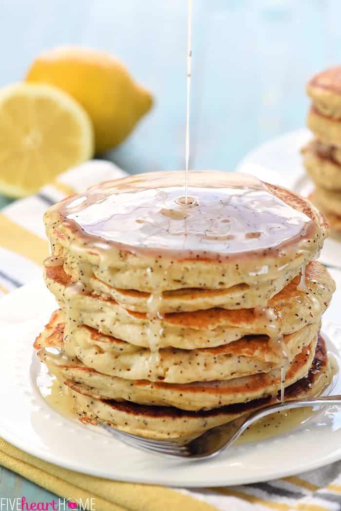 Whole Wheat Lemon Poppy Seed Pancakes ~ wholesome and delicious pancakes drizzled with a scrumptious Lemon Poppy Seed Syrup make a lovely spring or summer breakfast! | FiveHeartHome.com Lemon Syrup Being Poured on Top of Stack