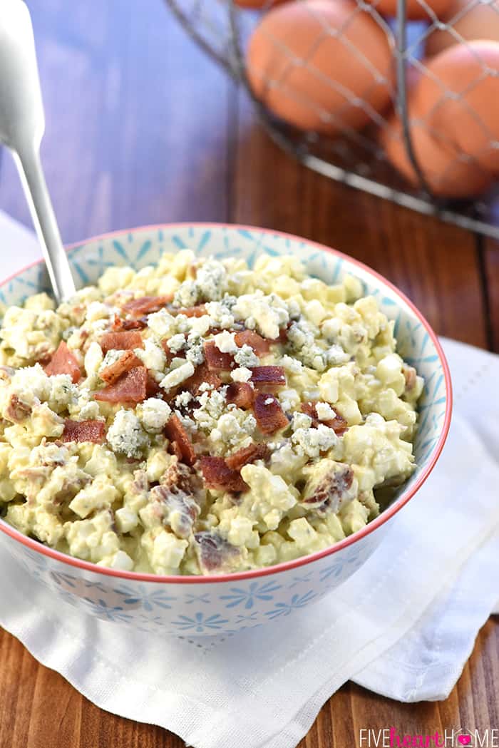 Serving bowl of Egg Salad with bacon and blue cheese sprinkled on top