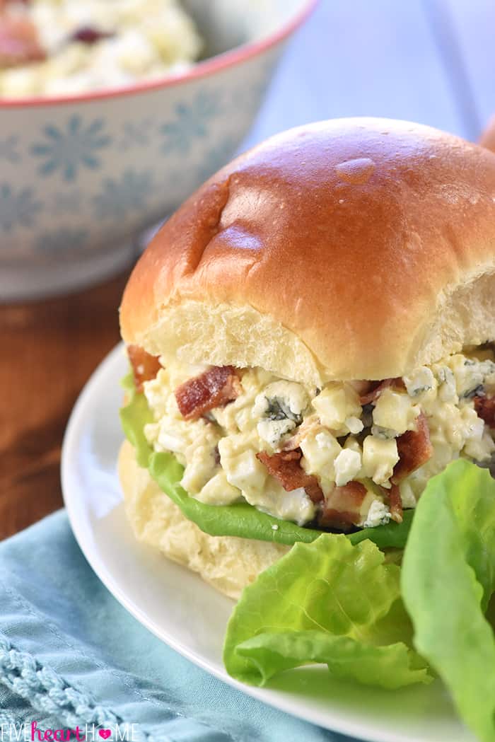 Egg Salad with Bacon and Blue Cheese ~ a flavorful filling for sandwiches or lettuce wraps, and a great recipe for using up leftover hard-boiled Easter eggs! | FiveHeartHome.com Close-up of sandwich on a plate with lettuce