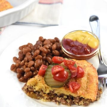 Cheeseburger Pie on a plate with garnishes.