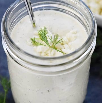 Homemade Feta Dressing in a mason jar with sprig of dill on top