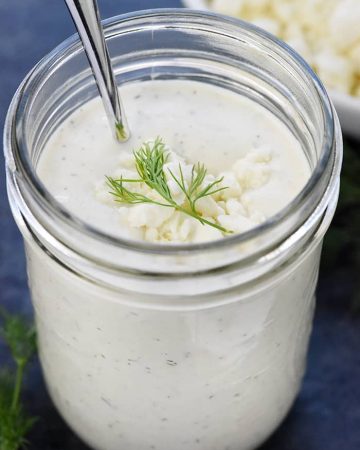 Homemade Feta Dressing in a mason jar with sprig of dill on top