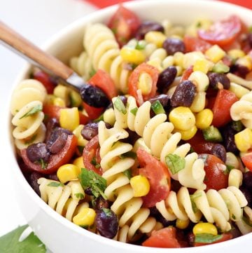 Mexican Pasta Salad in white bowl with spoon.