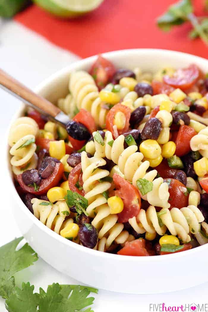 Mexican Pasta Salad in white bowl with spoon.