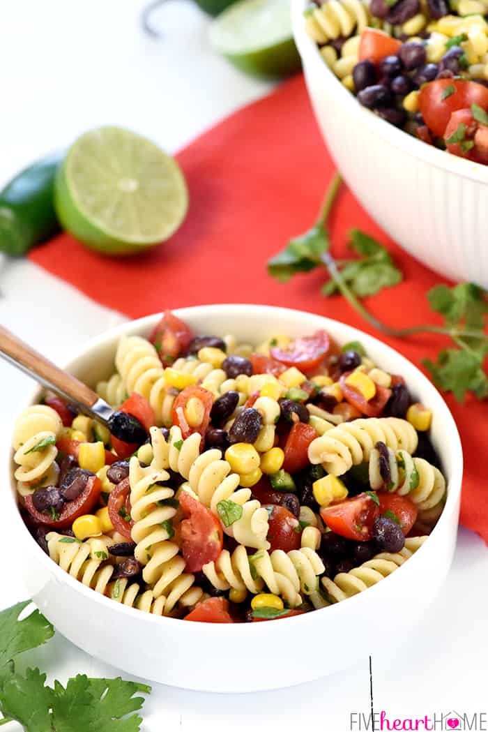 Mexican Pasta Salad in white bowl with spoon.