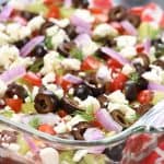 Greek 7-Layer Dip in glass serving dish.