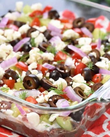 Greek 7-Layer Dip in glass serving dish.